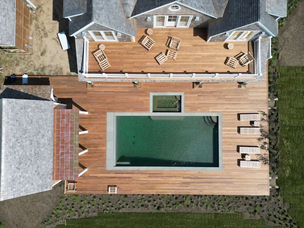 Aerial view of a large hardwood pool deck built by HawkPro Builders