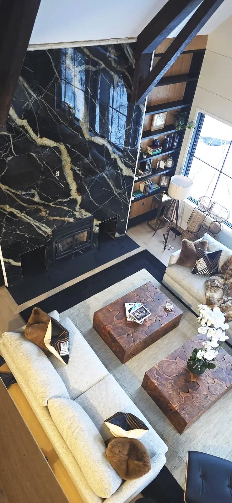Double-height black marble fireplace wall installed by HawkPro tile specialists